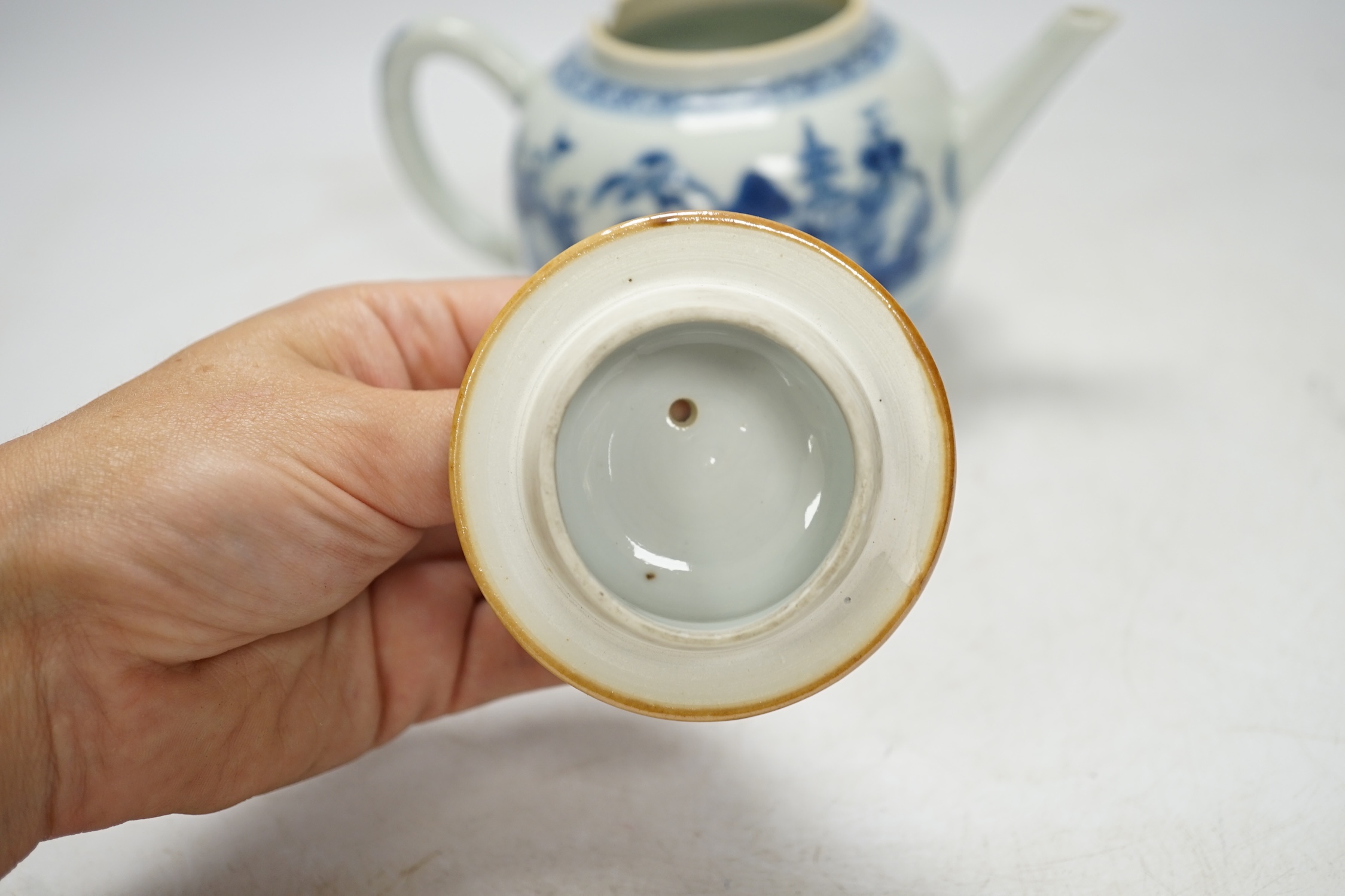 An 18th century Chinese blue and white teapot and cover, 12cm high. Condition - poor